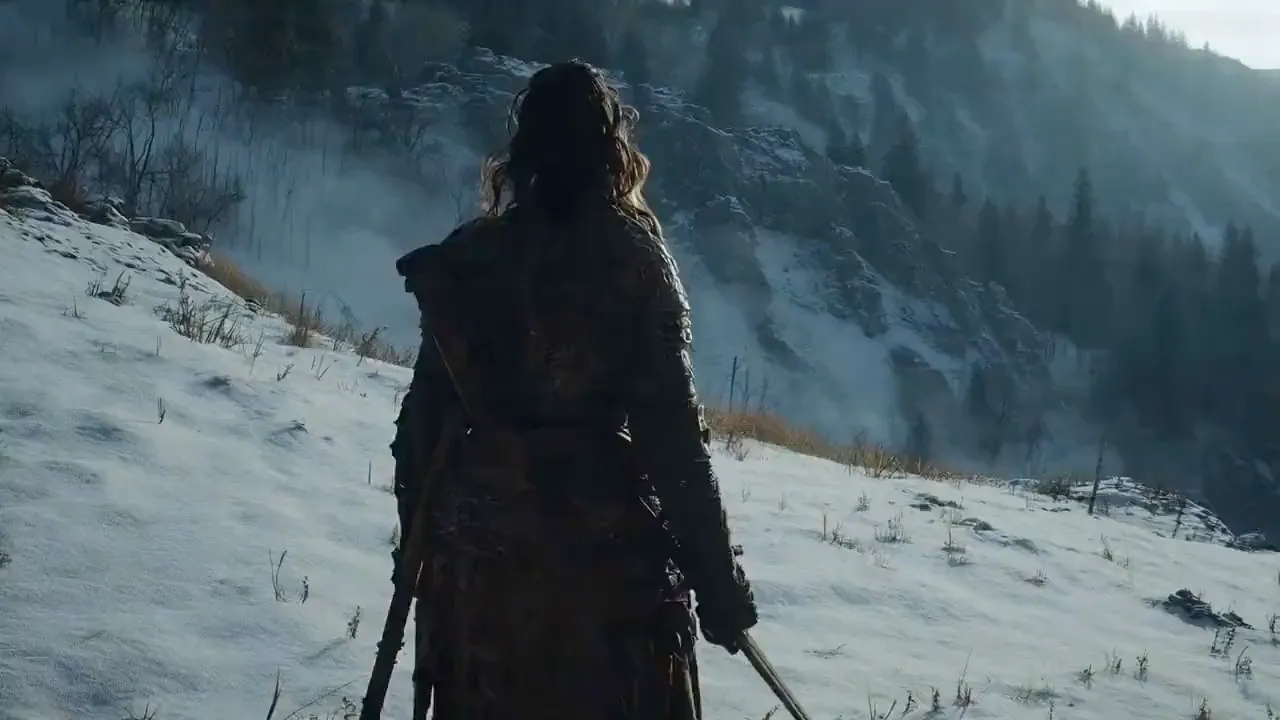 Traveler walking through a snowy mountain landscape